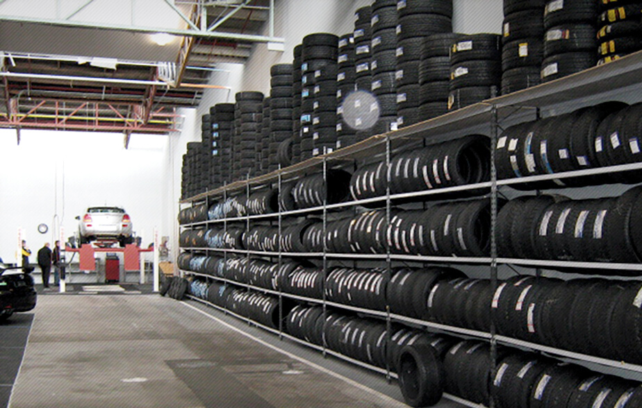 Tyres stored on shelving in tyre store